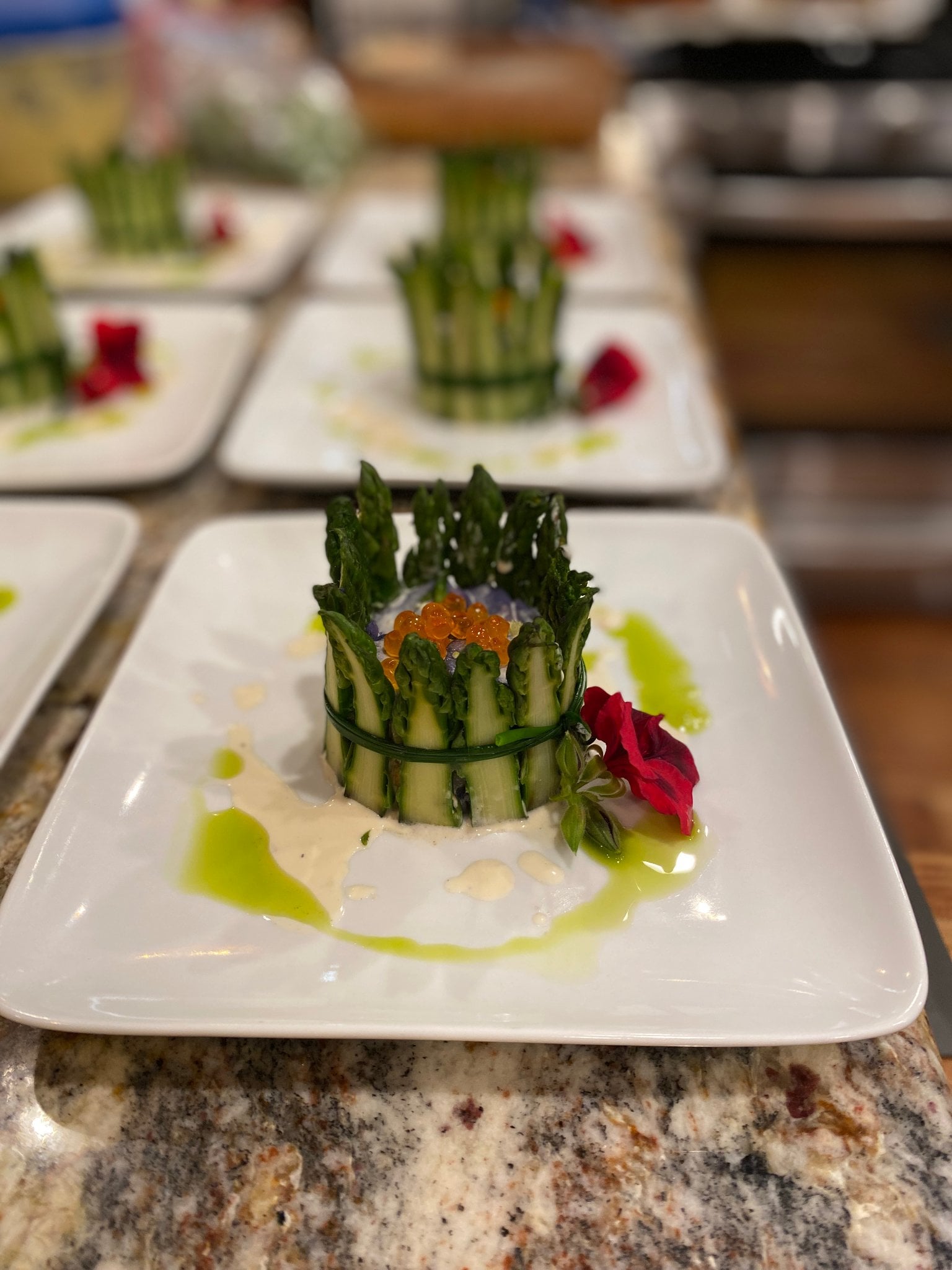 Chef finishing a plated course at Feast in the Garden